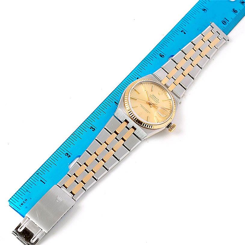 The image shows a Rolex Oysterquartz 17013 Men's Stainless Steel Champagne Dial 17013 Men's Stainless Steel Champagne Dial watch laid flat next to a blue ruler, displaying the full band and watch face.