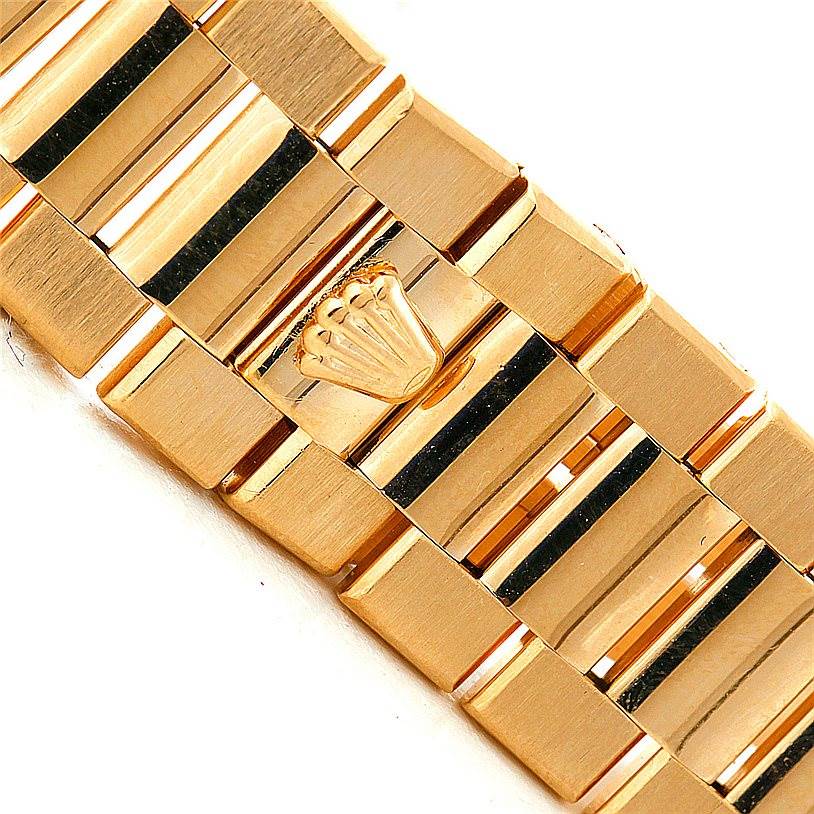 This image shows a close-up angle of the bracelet of a Rolex Oysterquartz 19018 Men's Yellow Gold Champagne Dial 19018 Men's Yellow Gold Champagne Dial watch, featuring the brand's logo.
