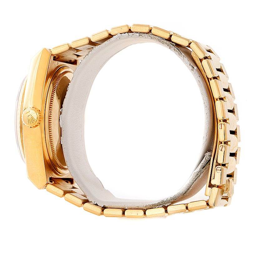 The image shows a side view of a Rolex Oysterquartz 19018 Men's Yellow Gold Champagne Dial 19018 Men's Yellow Gold Champagne Dial watch, highlighting its gold casing, crown, and bracelet.