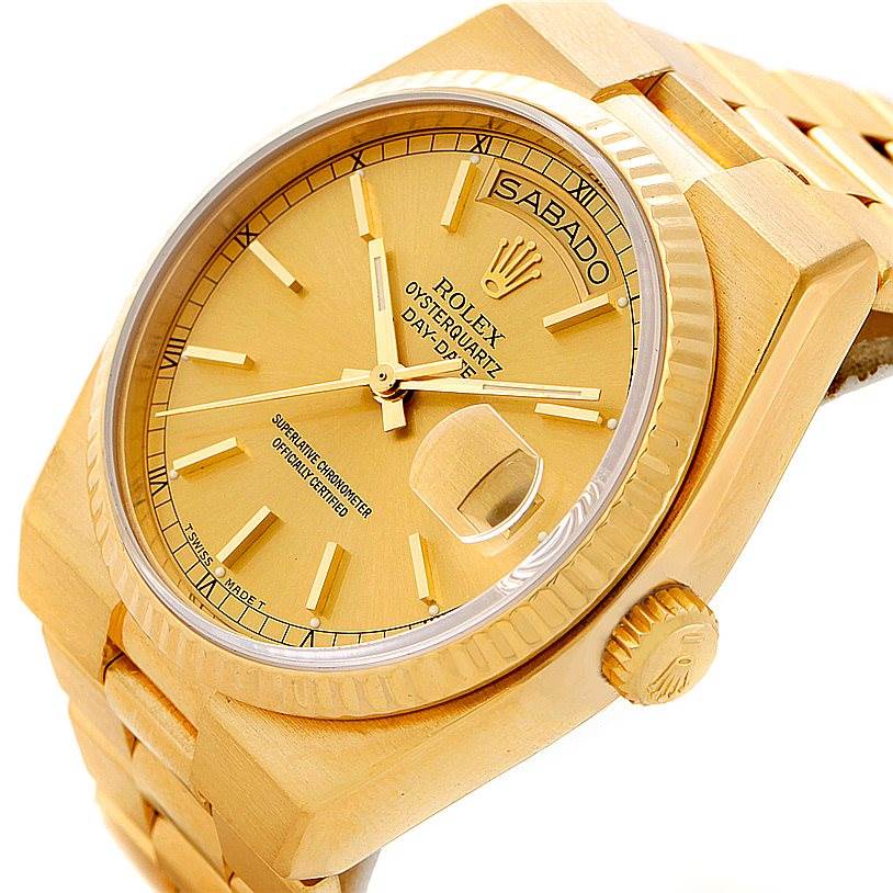 The Rolex Oysterquartz 19018 Men's Yellow Gold Champagne Dial 19018 Men's Yellow Gold Champagne Dial watch is shown at a slight angle, highlighting the dial, day-date display, bezel, and part of the bracelet.
