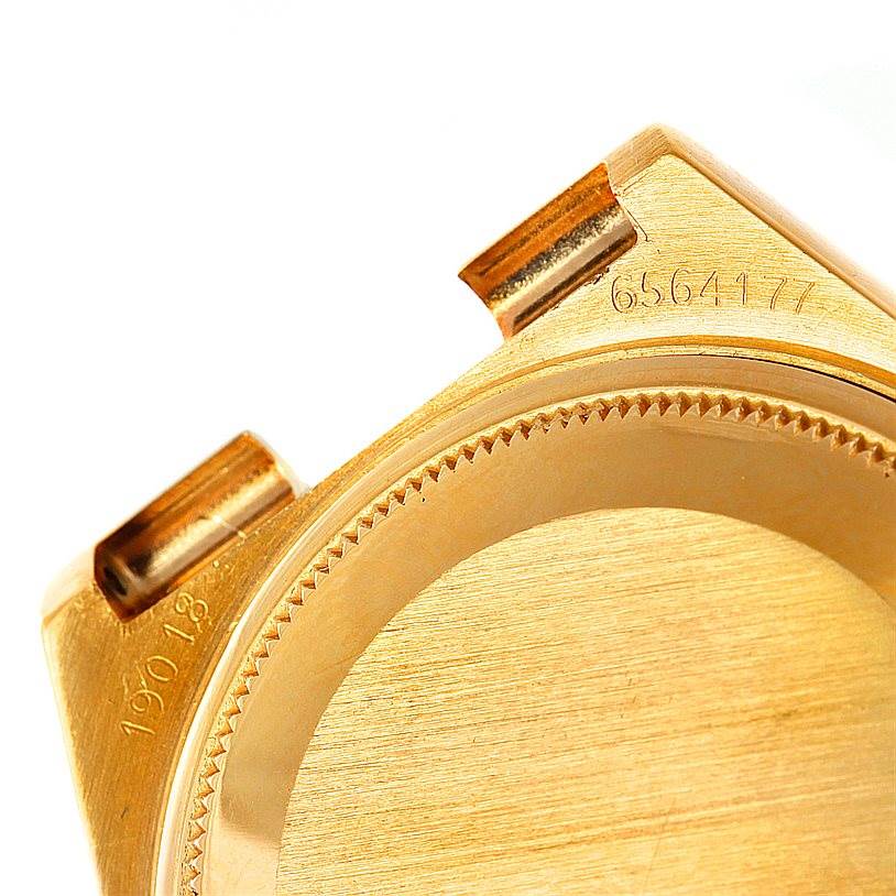 The image displays a close-up of a gold case back and lug area of a Rolex Oysterquartz 19018 Men's Yellow Gold Champagne Dial 19018 Men's Yellow Gold Champagne Dial watch, revealing part of the serial number.