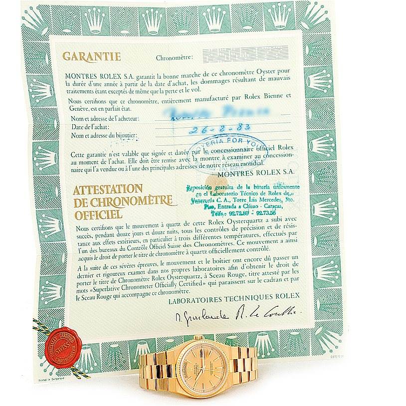 The image shows a Rolex Oysterquartz 19018 Men's Yellow Gold Champagne Dial 19018 Men's Yellow Gold Champagne Dial watch and warranty certificate, viewed from the front.