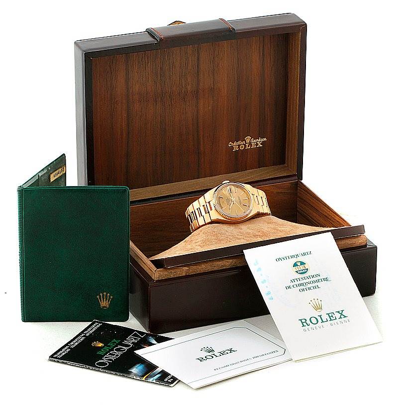 The image shows a Rolex Oysterquartz 19018 Men's Yellow Gold Champagne Dial 19018 Men's Yellow Gold Champagne Dial watch with its full packaging, including the watch, its box, and accompanying documentation.
