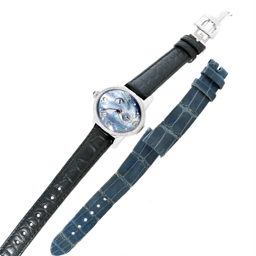 The image shows the face and straps of the Girard-Perregaux 80481 Women's White Gold Mother of Pearl Dial 80481 Women's White Gold Mother of Pearl Dial Cat's Eye 18K White Gold Diamond Watch 80481, along with an additional blue strap.