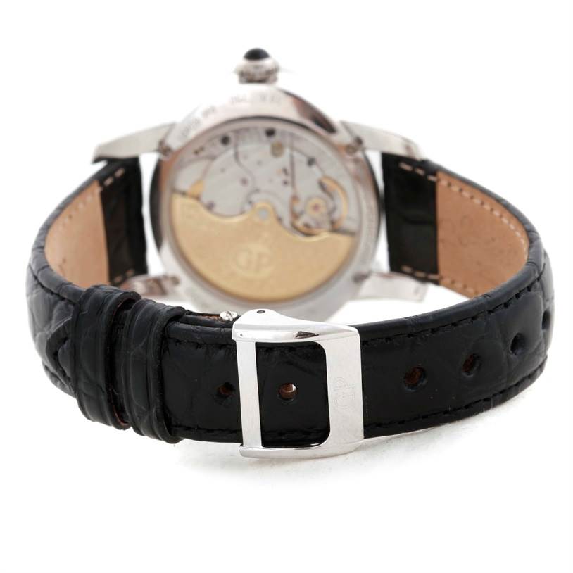 The image shows the rear view of the Girard-Perregaux 80481 Women's White Gold Mother of Pearl Dial 80481 Women's White Gold Mother of Pearl Dial Cat's Eye 18K White Gold Diamond Watch 80481 with its open case back and black leather strap.