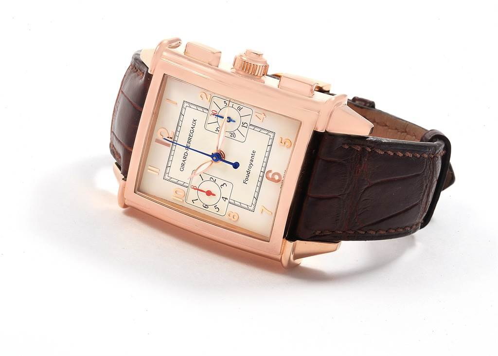 The image shows a Girard-Perregaux 9021 Men's Rose Gold Silver Dial 9021 Men's Rose Gold Silver Dial 1945 Rose Gold Split Second Chrono Watch 9021 from an angled side view, highlighting the face and strap.