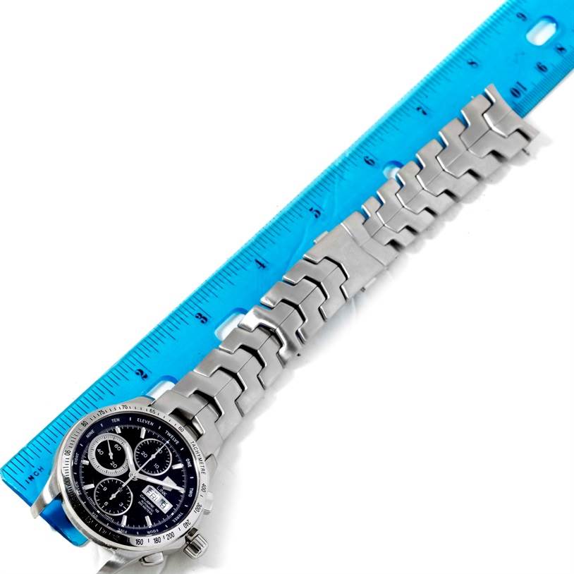 The image shows the Tag Heuer Link CJF211A.BA0594 Men's Stainless Steel Black Dial CJF211A.BA0594 Men's Stainless Steel Black Dial model watch placed next to a ruler, displaying the watch face and stainless steel bracelet.
