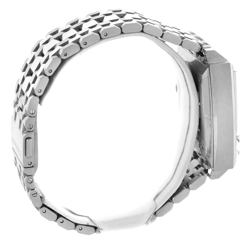 The image shows a side view of the Monaco model by Tag Heuer, highlighting the bracelet and case.