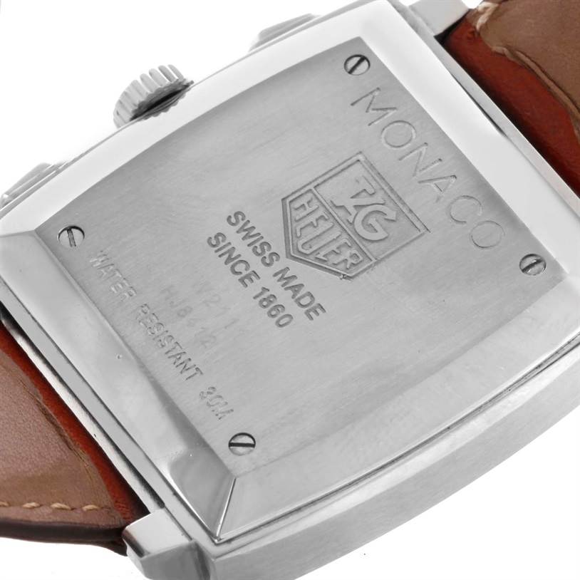 The image shows the back case of the Tag Heuer Monaco CW2111 Men's Stainless Steel Black Dial CW2111 Men's Stainless Steel Black Dial watch with engraving, including the brand logo and text.