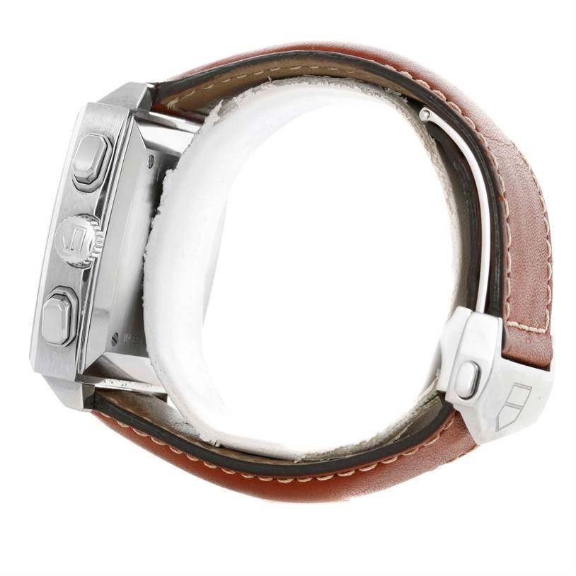 The image shows a side view of the Tag Heuer Monaco CW2111 Men's Stainless Steel Black Dial CW2111 Men's Stainless Steel Black Dial watch highlighting the crown, pushers, and part of the brown leather strap.