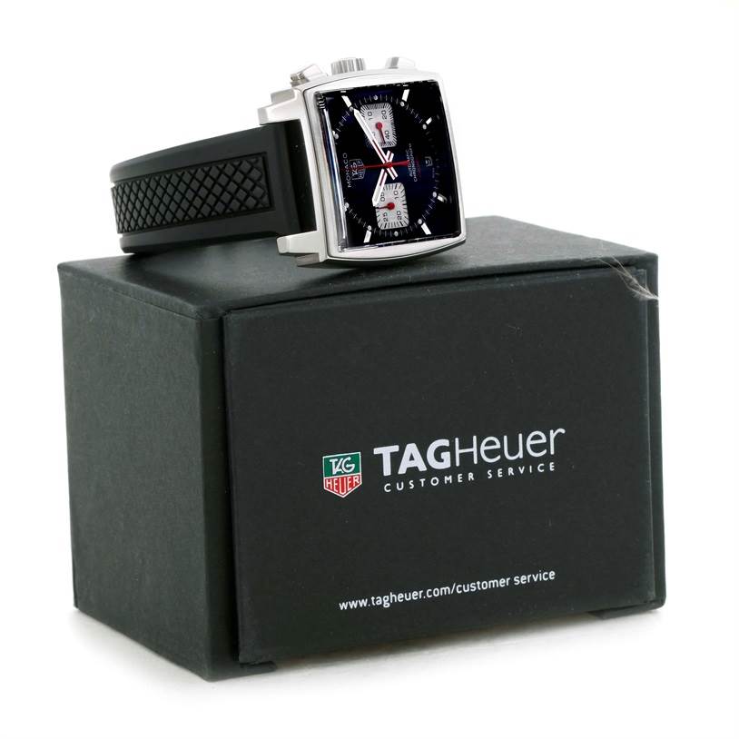 The image shows a Tag Heuer Monaco CAW2114 Men's Stainless Steel Black Dial CAW2114 Men's Stainless Steel Black Dial watch at a three-quarter angle, displaying the square face and part of the black strap, above its box.