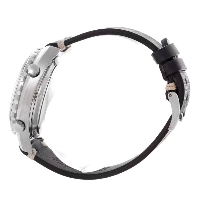 The image shows a side view of a Tag Heuer Autavia 1163 Men's Stainless Steel Black Dial 1163 Men's Stainless Steel Black Dial watch, highlighting the case, crown, and leather strap.