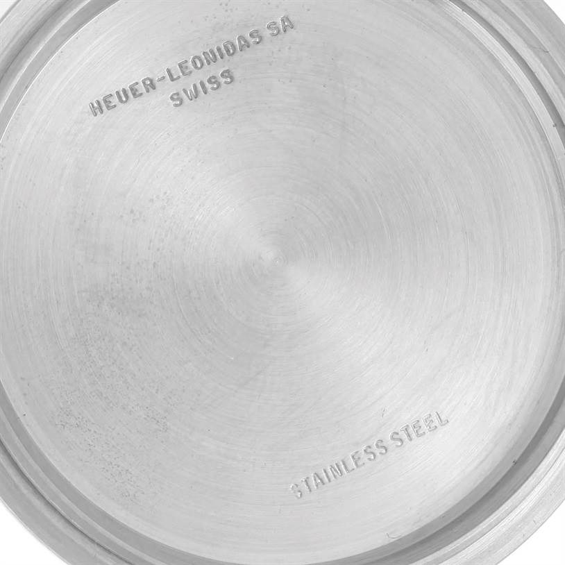 This image shows the inside case back of a Tag Heuer Autavia 1163 Men's Stainless Steel Black Dial 1163 Men's Stainless Steel Black Dial watch, indicating "Heuer-Leonidas SA" and "Stainless Steel."