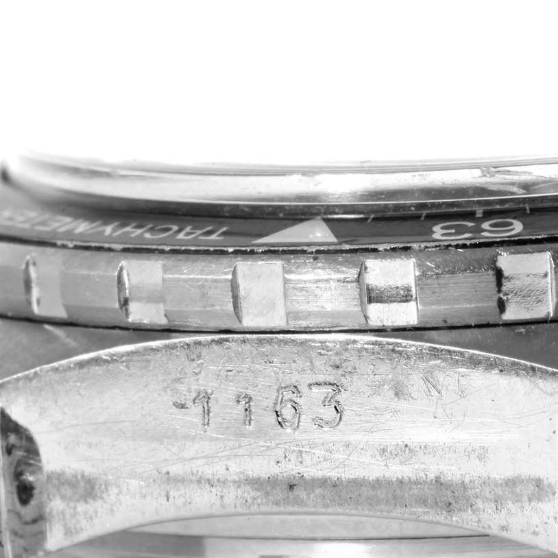 This close-up image shows the side of the bezel and case of a Tag Heuer Autavia 1163 Men's Stainless Steel Black Dial 1163 Men's Stainless Steel Black Dial watch, focusing on the engraved model number "1163."