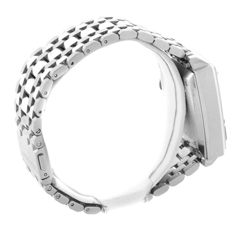 This side angle of the Tag Heuer Monaco CW2113 Men's Stainless Steel Blue Dial CW2113 Men's Stainless Steel Blue Dial watch shows its metal bracelet and part of the watch case.