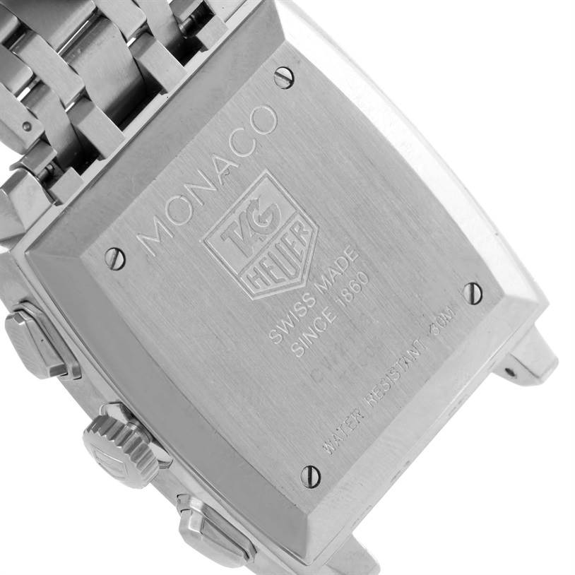 The image shows the back case and part of the bracelet of a Tag Heuer Monaco CW2113 Men's Stainless Steel Blue Dial CW2113 Men's Stainless Steel Blue Dial watch, engraved with the brand and model details.