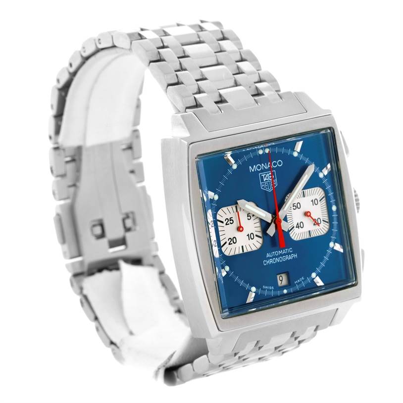 The image shows a Tag Heuer Monaco CW2113 Men's Stainless Steel Blue Dial CW2113 Men's Stainless Steel Blue Dial watch at an angle displaying its blue face, side buttons, and stainless steel bracelet.