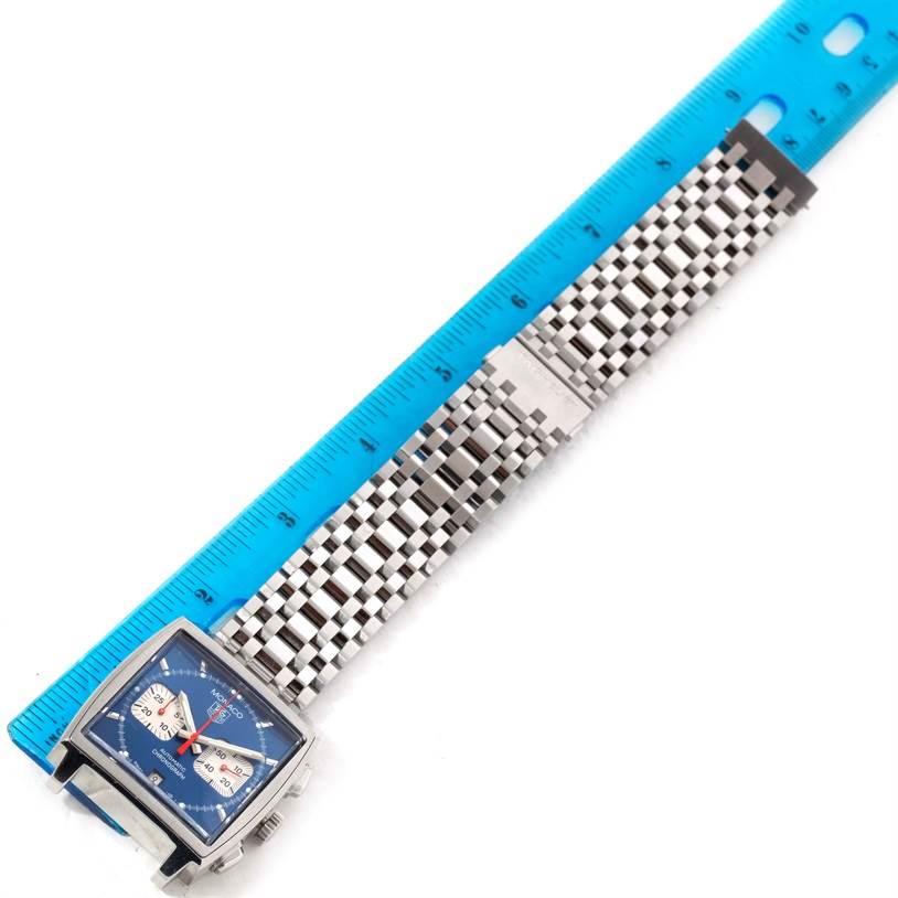 The Tag Heuer Monaco CW2113 Men's Stainless Steel Blue Dial CW2113 Men's Stainless Steel Blue Dial watch is viewed from above, showing its face, case, and metal bracelet alongside a ruler.