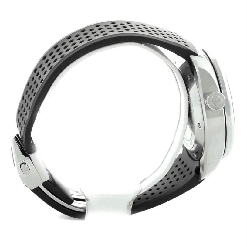 The image shows a side view of a Tag Heuer Carrera CAV5115 Men's Stainless Steel Black Dial CAV5115 Men's Stainless Steel Black Dial watch, highlighting the perforated strap and side casing with the brand's logo on the crown.