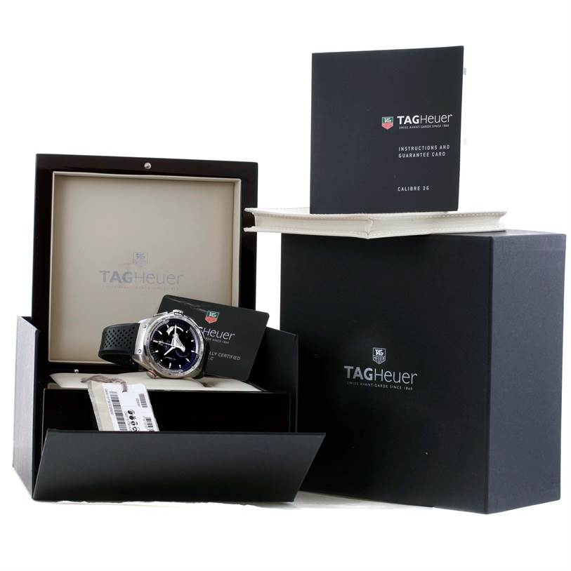 The image shows a Tag Heuer Carrera CAV5115 Men's Stainless Steel Black Dial CAV5115 Men's Stainless Steel Black Dial watch with its packaging, instructions, and guarantee card from a front-left angle.
