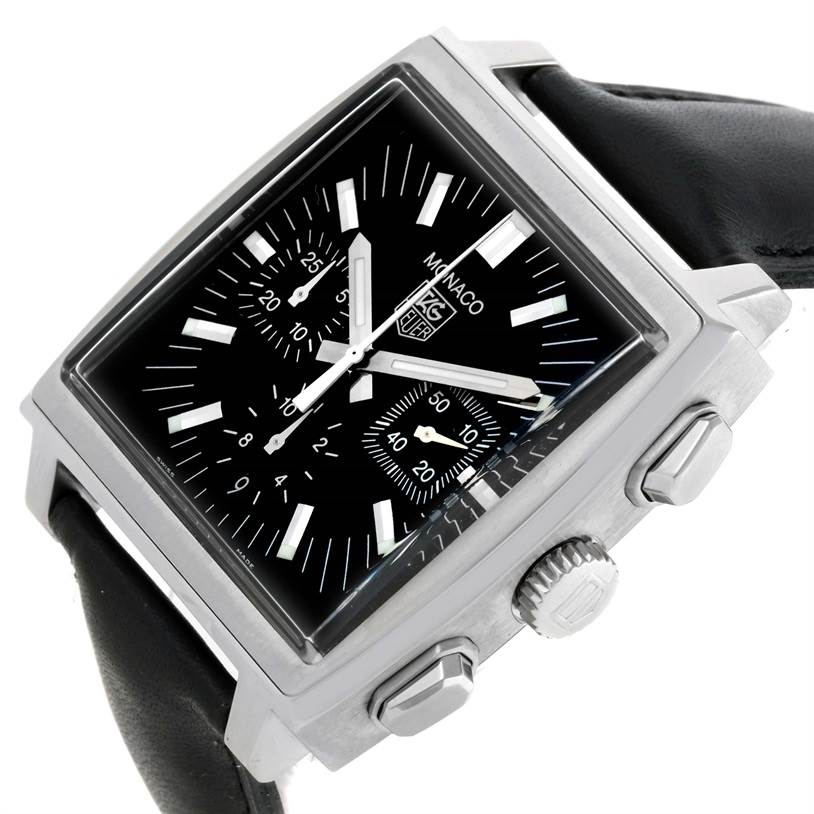 The image shows a Tag Heuer Monaco CW2111 Men's Stainless Steel Black Dial CW2111 Men's Stainless Steel Black Dial watch at an oblique angle, featuring the face, crown, pushers, and part of the leather strap.