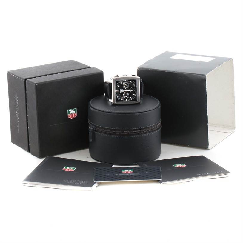 This image shows a Tag Heuer Monaco CW2111 Men's Stainless Steel Black Dial CW2111 Men's Stainless Steel Black Dial model watch at a frontal angle, along with its box, case, and manuals.