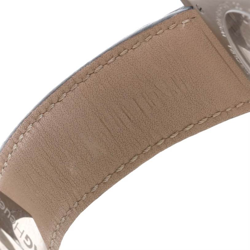 This image shows a close-up of the leather strap and part of the buckle of a Tag Heuer Monaco CAW2111 Men's Stainless Steel Blue Dial CAW2111 Men's Stainless Steel Blue Dial watch.