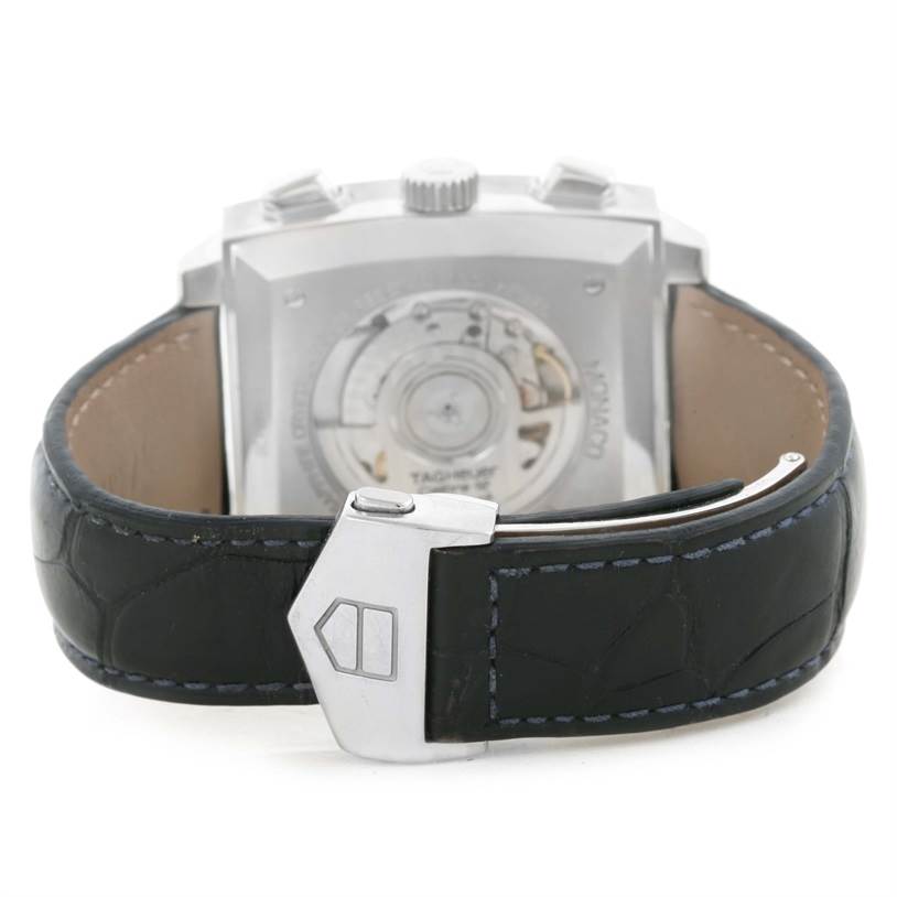 The image shows the back view of a Tag Heuer Monaco CAW2111 Men's Stainless Steel Blue Dial CAW2111 Men's Stainless Steel Blue Dial watch, highlighting the clasp, strap, and transparent case back.