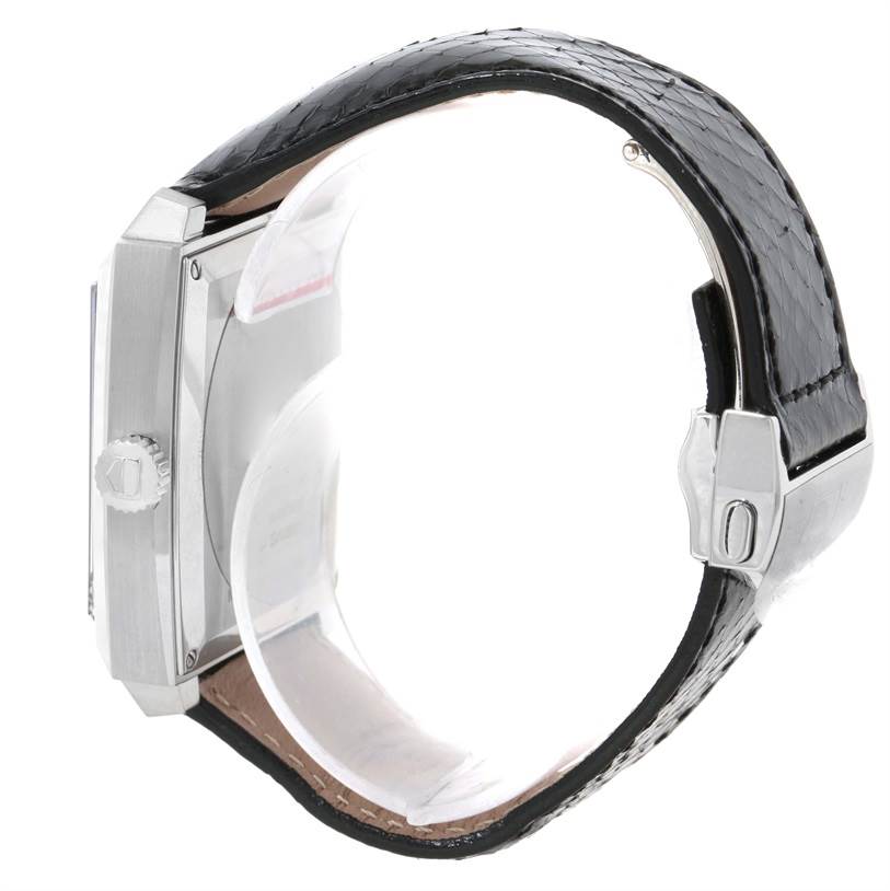 The Tag Heuer Monaco WAW1310.FC6216 Men's Stainless Steel Black Dial WAW1310.FC6216 Men's Stainless Steel Black Dial watch is shown from a side angle, highlighting the case, crown, and black leather strap.