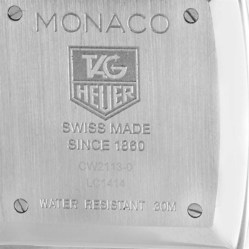 The image shows the back side of a Tag Heuer Monaco CW2113 Men
s Stainless Steel Blue Dial CW2113 Men
s Stainless Steel Blue Dial watch, highlighting its engravings and screw details.