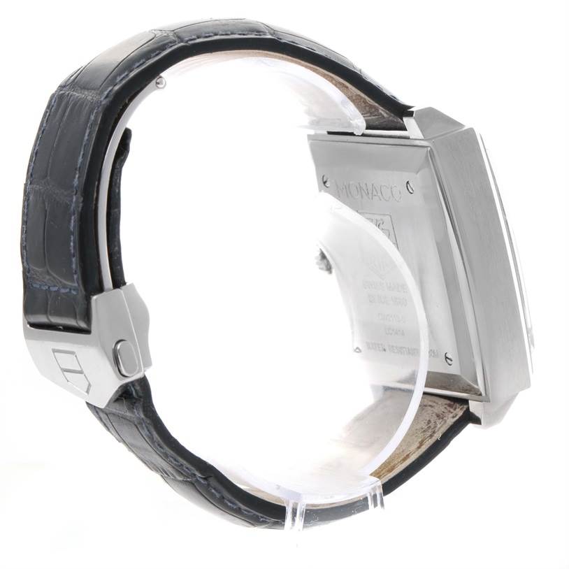The image shows a side view of the Tag Heuer Monaco CW2113 Men
s Stainless Steel Blue Dial CW2113 Men
s Stainless Steel Blue Dial watch, highlighting its leather strap and stainless steel case back.