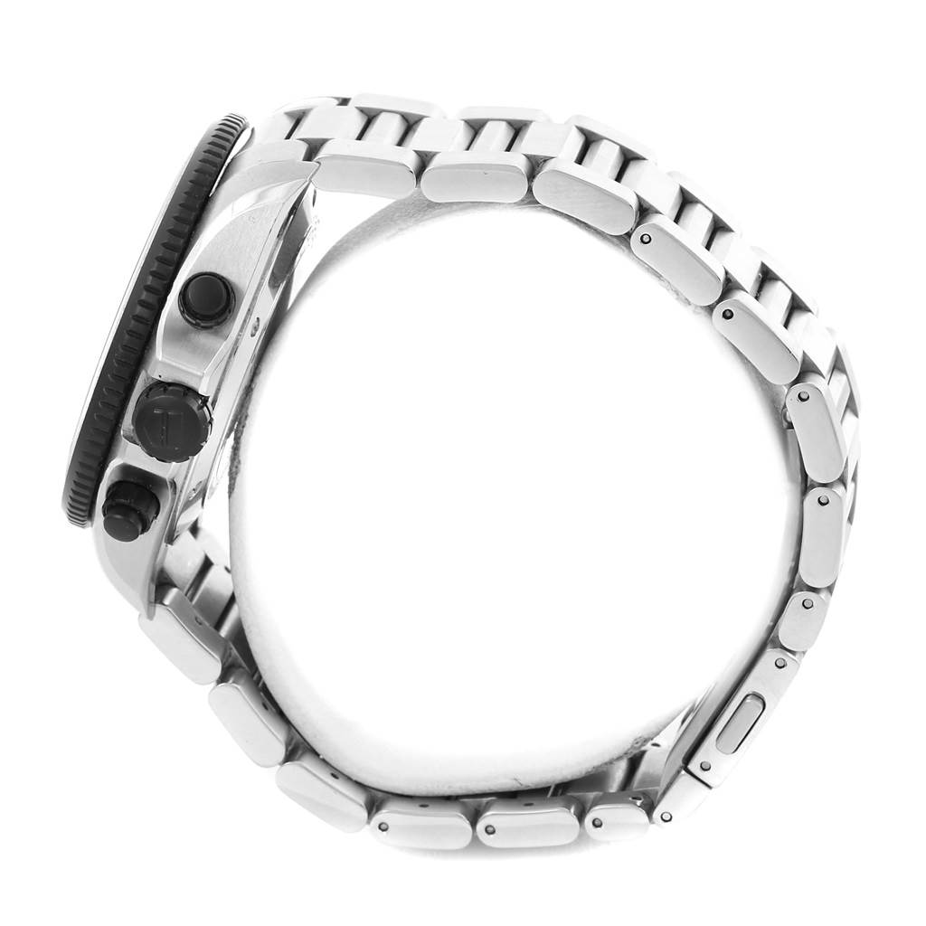 The image shows a side view of a Tag Heuer Carrera CAV511C Men's Titanium Black Dial CAV511C Men's Titanium Black Dial watch, revealing the crown, pushers, bezel, and stainless steel bracelet.