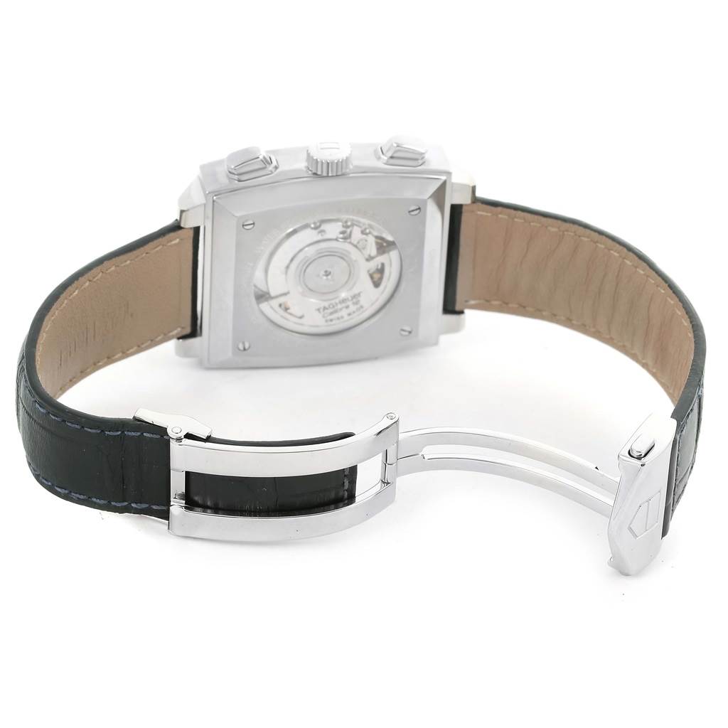 The image shows the back view of a Tag Heuer Monaco CAW2111 Men's Stainless Steel Blue Dial CAW2111 Men's Stainless Steel Blue Dial watch, highlighting the case back and the open clasp on the leather strap.