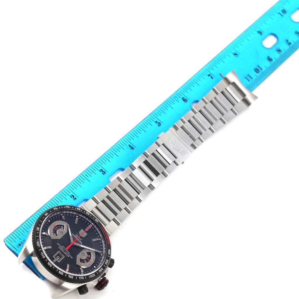 The image shows a Tag Heuer Carrera CAV511C Men's Titanium Black Dial CAV511C Men's Titanium Black Dial watch with a partial front view and stainless steel bracelet measured against a blue ruler.