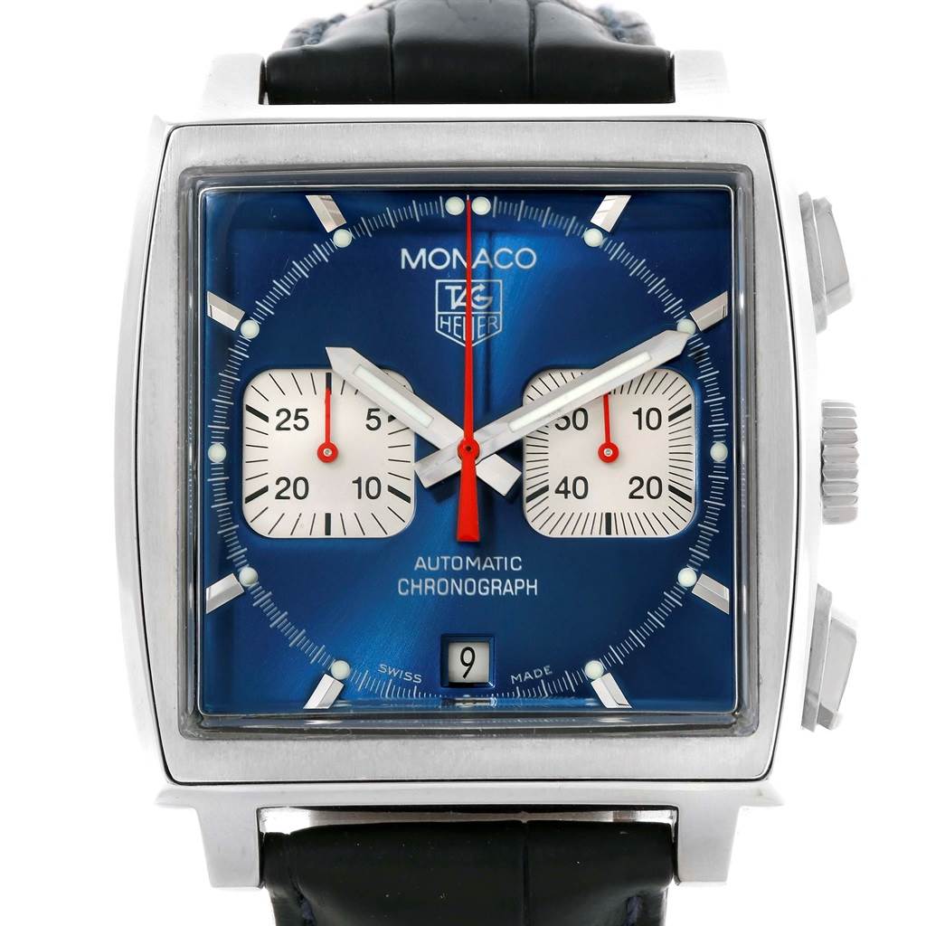 The image shows the face of a Tag Heuer Monaco CW2113 Men's Stainless Steel Blue Dial CW2113 Men's Stainless Steel Blue Dial watch with a blue dial, two subdials, and a date window at an angle that displays the entire watch's front.