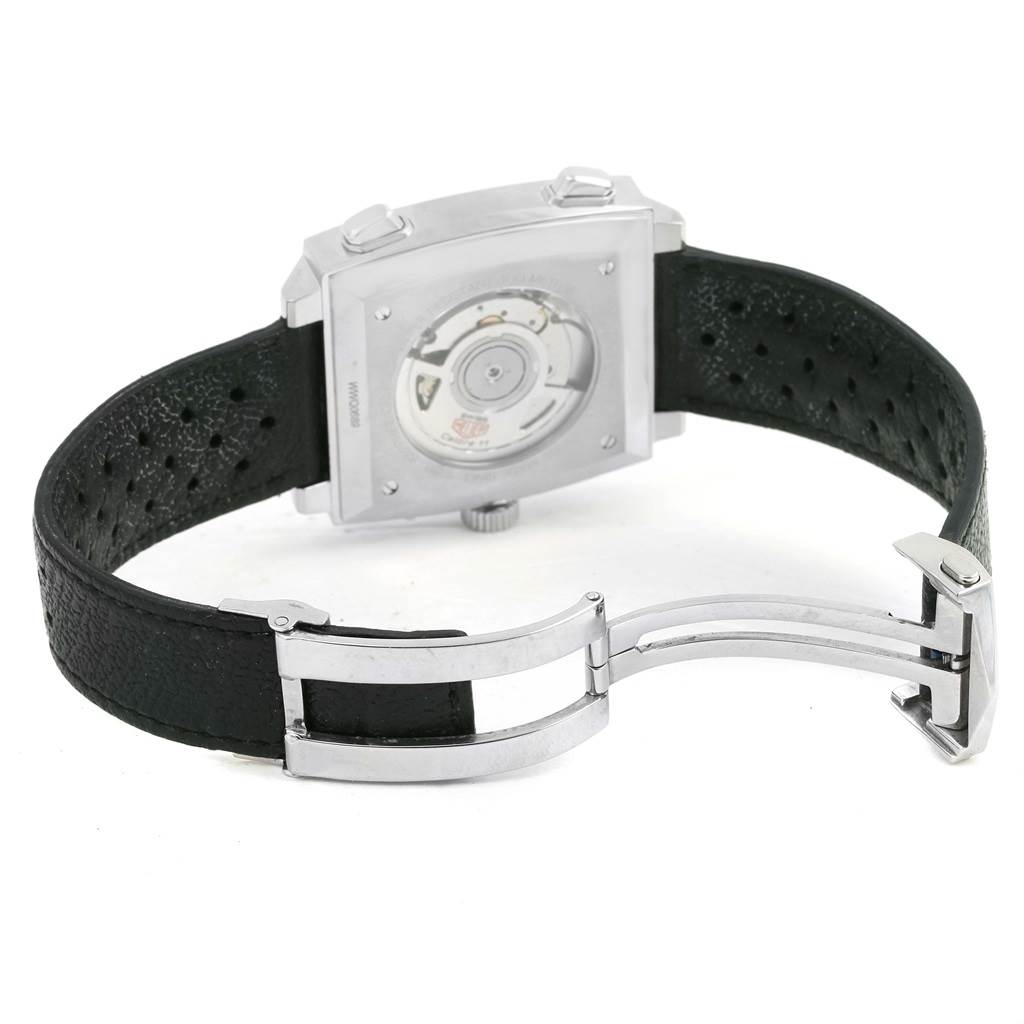 The image shows the back view of a Tag Heuer Monaco CAW211P Men's Stainless Steel Blue Dial CAW211P Men's Stainless Steel Blue Dial watch, displaying its movement and black perforated strap with a deployment clasp.