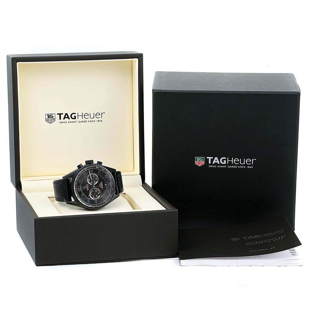 The image shows a Tag Heuer Carrera CAR2B80.FC6325 Men's Titanium Black Dial CAR2B80.FC6325 Men's Titanium Black Dial watch from the front in its open box, with an outer box and manuals beside it.
