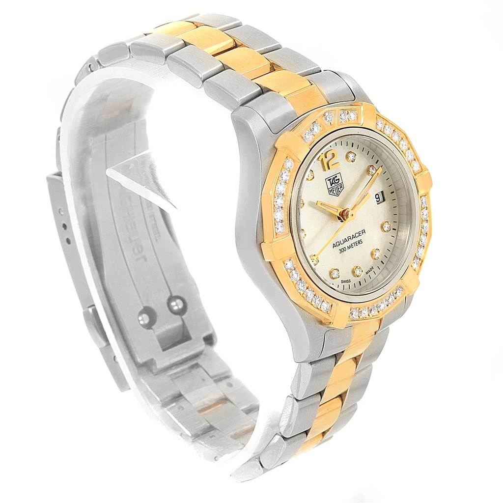 This Tag Heuer Aquaracer WAF1450.BA0825 Women
s Steel and Gold (two tone) Mother of Pearl Dial WAF1450.BA0825 Women
s Steel and Gold (two tone) Mother of Pearl Dial watch is shown at a three-quarter angle, displaying its dial, bezel, and two-tone bracelet.