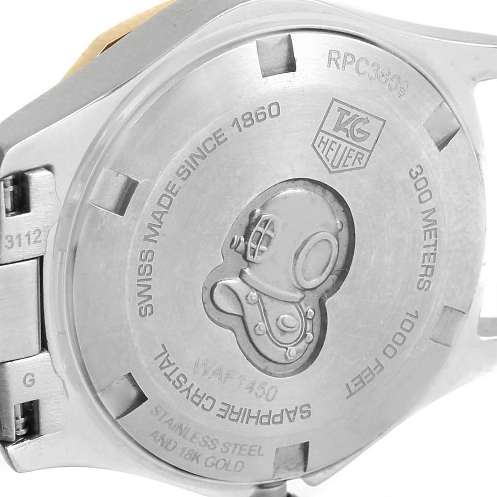 The image shows the back case of a Tag Heuer Aquaracer WAF1450.BA0825 Women
s Steel and Gold (two tone) Mother of Pearl Dial WAF1450.BA0825 Women
s Steel and Gold (two tone) Mother of Pearl Dial watch, featuring the brand
s logo and a diving helmet engraving.