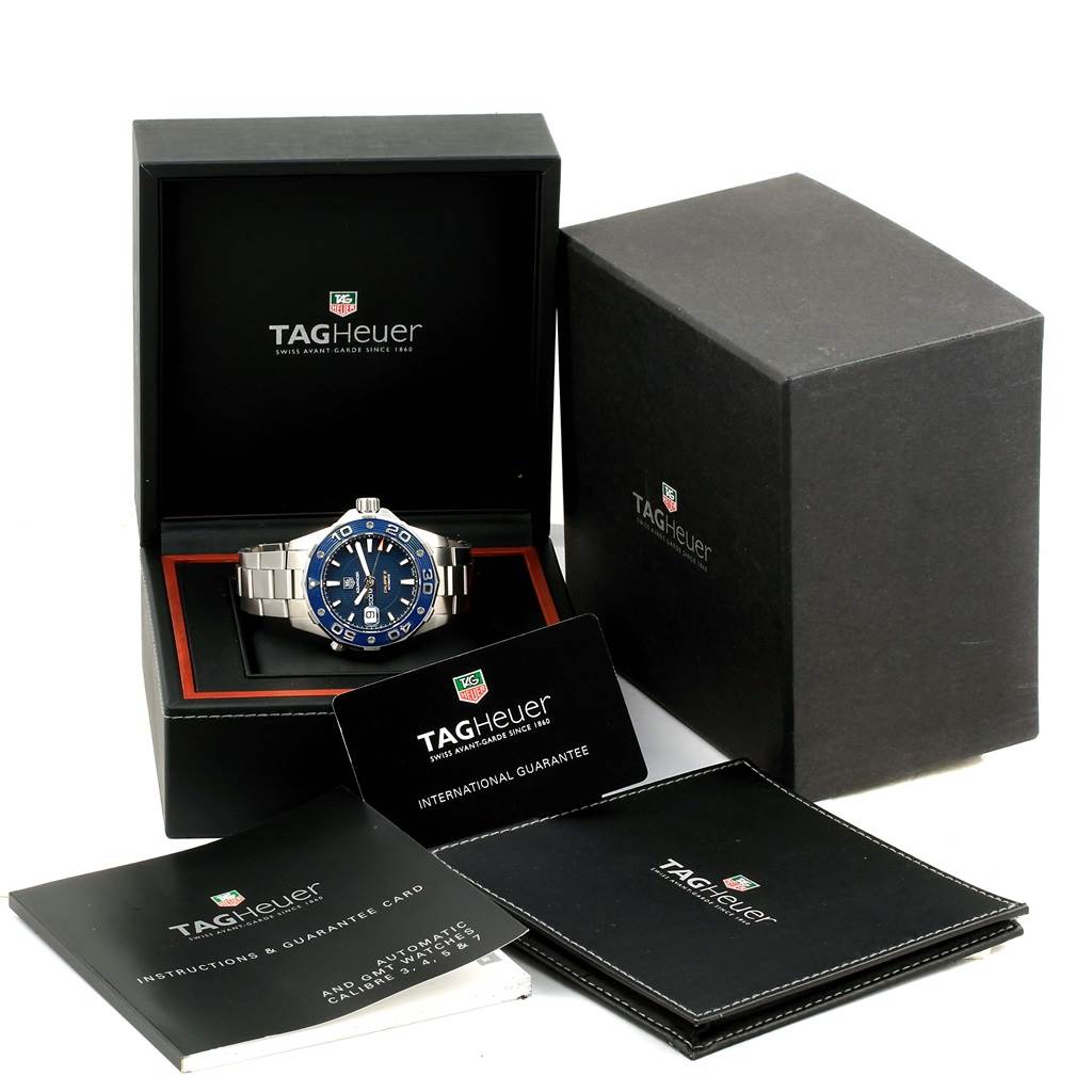 The image shows a Tag Heuer Aquaracer RWC2411 Men's Stainless Steel Blue Dial RWC2411 Men's Stainless Steel Blue Dial watch at an angle, with its box, manuals, and warranty card.