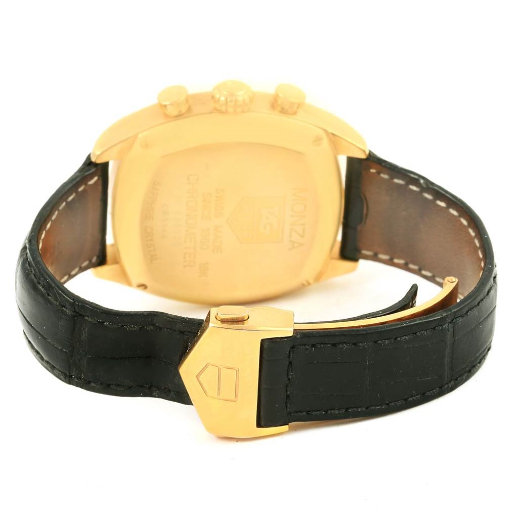 The image shows the back of a Tag Heuer Monza CR514A Men's Yellow Gold Silver Dial CR514A Men's Yellow Gold Silver Dial watch, including the case, crown, and black leather strap with a gold buckle.