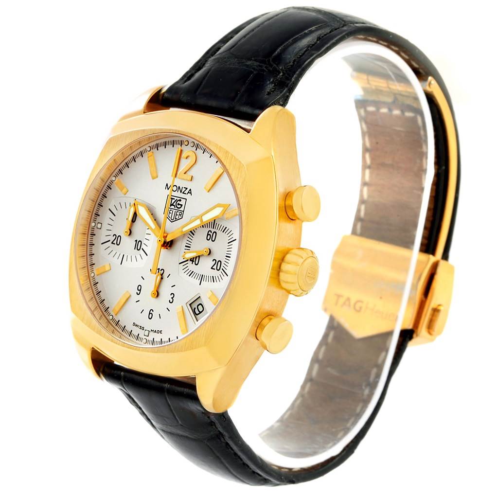 This Tag Heuer Monza CR514A Men's Yellow Gold Silver Dial CR514A Men's Yellow Gold Silver Dial watch is shown at a three-quarter angle, displaying its gold case, white dial, black strap, and pushers.