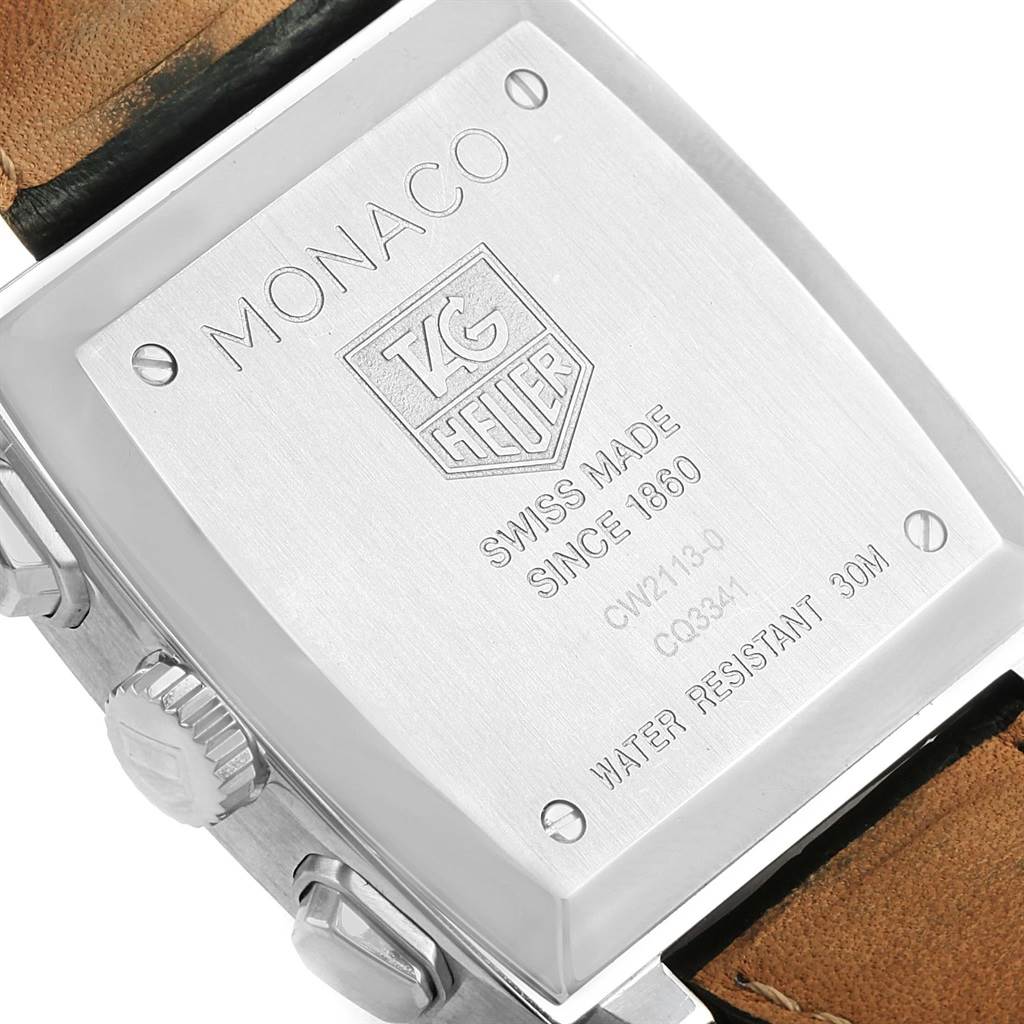 This image shows the back case of the Tag Heuer Monaco CW2113 Men
s Stainless Steel Blue Dial CW2113 Men
s Stainless Steel Blue Dial watch at an angle emphasizing the engraved details and crown.