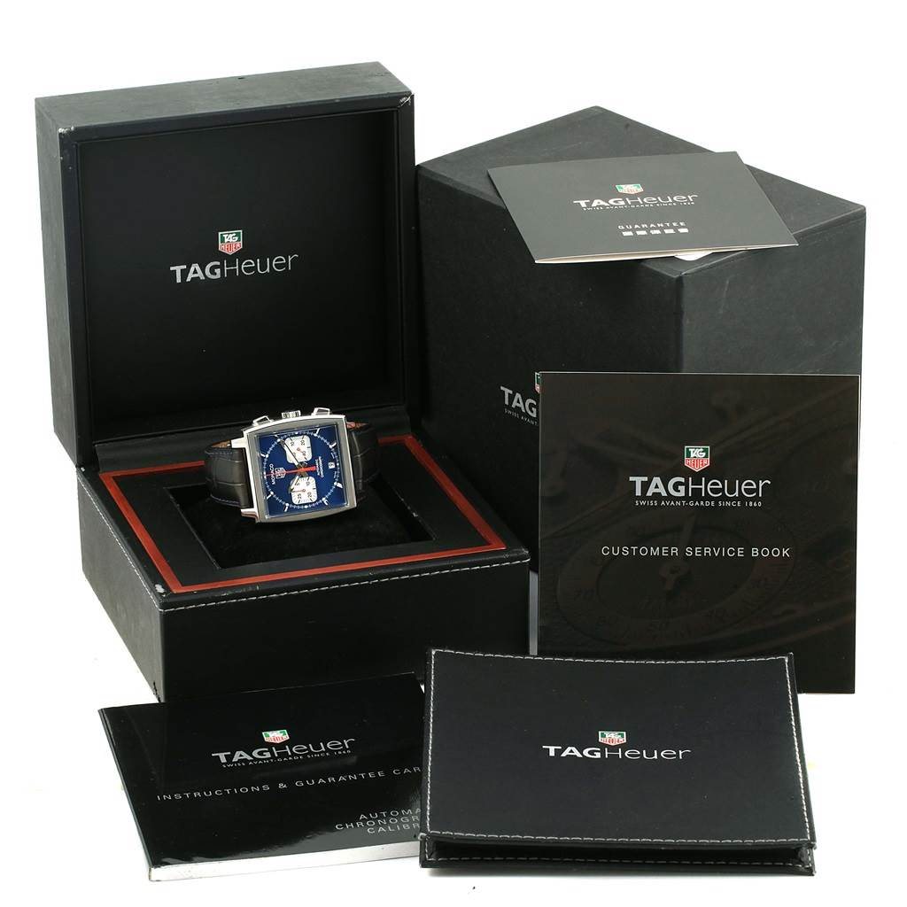 The image shows the Tag Heuer Monaco CW2113 Men
s Stainless Steel Blue Dial CW2113 Men
s Stainless Steel Blue Dial watch with its box, instruction manual, customer service book, and guarantee card.