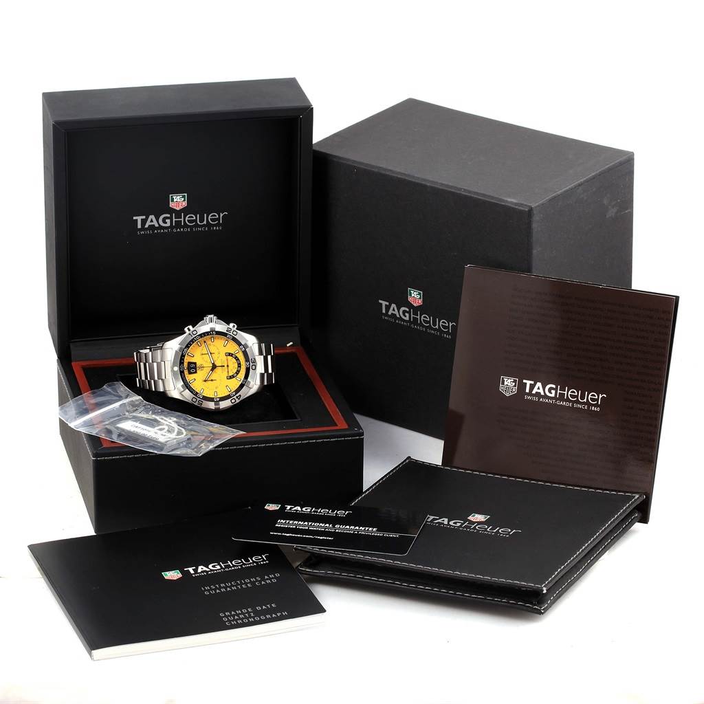 The image shows a Tag Heuer Aquaracer CAF101D.BA0821 Men's Stainless Steel Yellow Dial CAF101D.BA0821 Men's Stainless Steel Yellow Dial watch with a yellow face, displayed in its open box, along with packaging and booklets.