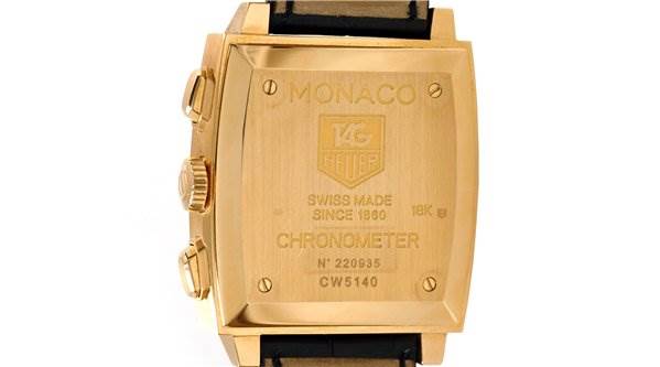 The image shows the back view of a Tag Heuer Monaco CW5140 Men's Yellow Gold Silver Dial CW5140 Men's Yellow Gold Silver Dial watch, highlighting the case back and side buttons.