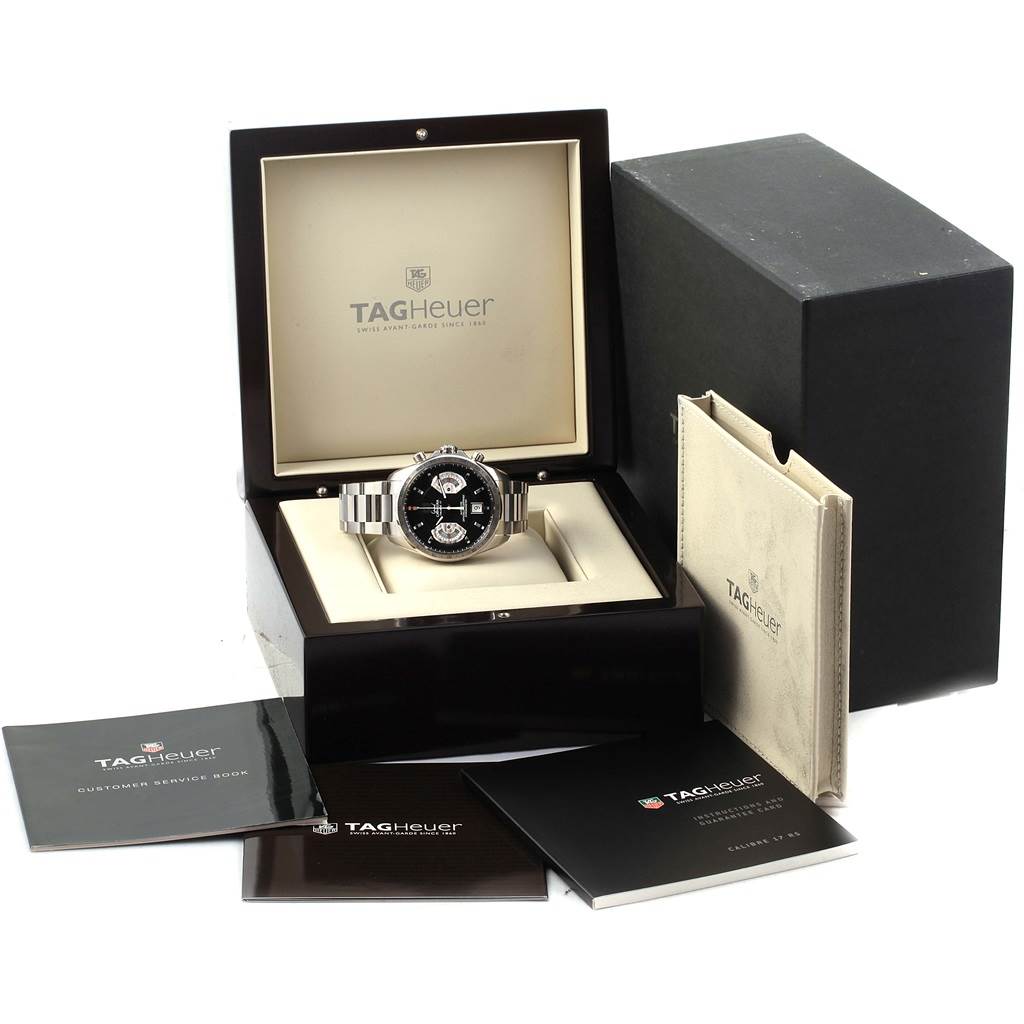 The Tag Heuer Carrera CAV511A Men's Stainless Steel Black Dial CAV511A Men's Stainless Steel Black Dial watch is presented in its box, with booklets and packaging visible around it.