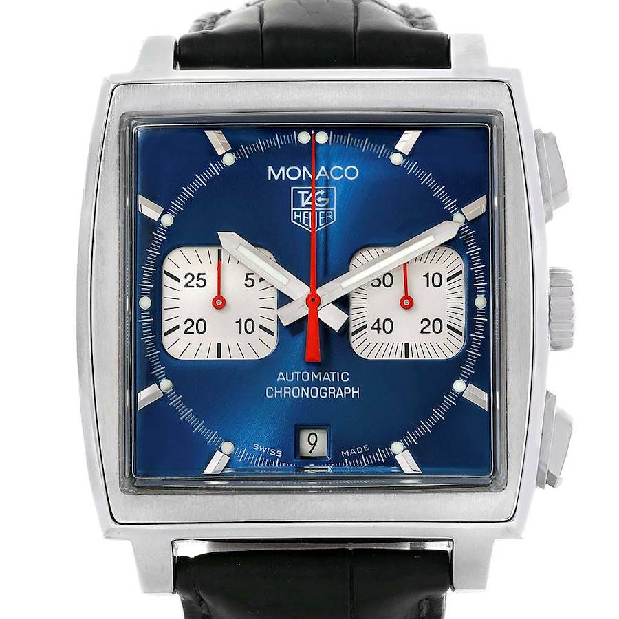 The Monaco model by Tag Heuer is shown from the front, displaying the blue dial, subdials, date window, and leather strap.