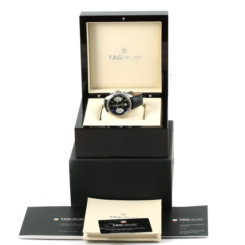 The image shows a Tag Heuer Carrera CAV511A.FC6225 Men's Stainless Steel Black Dial CAV511A.FC6225 Men's Stainless Steel Black Dial watch in its open box, with accompanying booklets and documents displayed nearby.