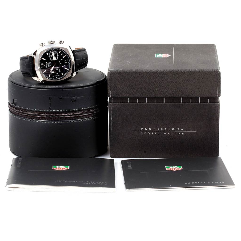 The image shows a Tag Heuer Monza CR2113.FC6164 Men's Stainless Steel Black Dial CR2113.FC6164 Men's Stainless Steel Black Dial watch, its round case, a box, and two booklets from a front angle.